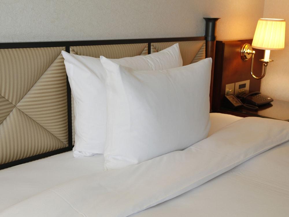 岐阜长良川都酒店 外观 照片 A pillow on a bed